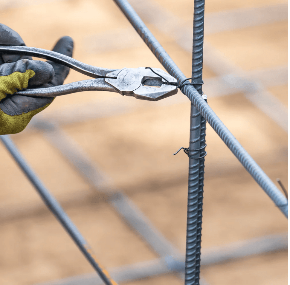 Tying wire with pliers, a simple and effective method.